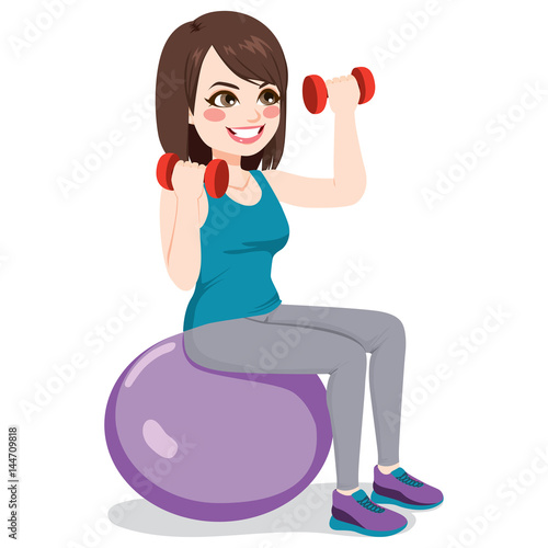 Beautiful brunette fitness woman training with dumbbells on exercise ball
