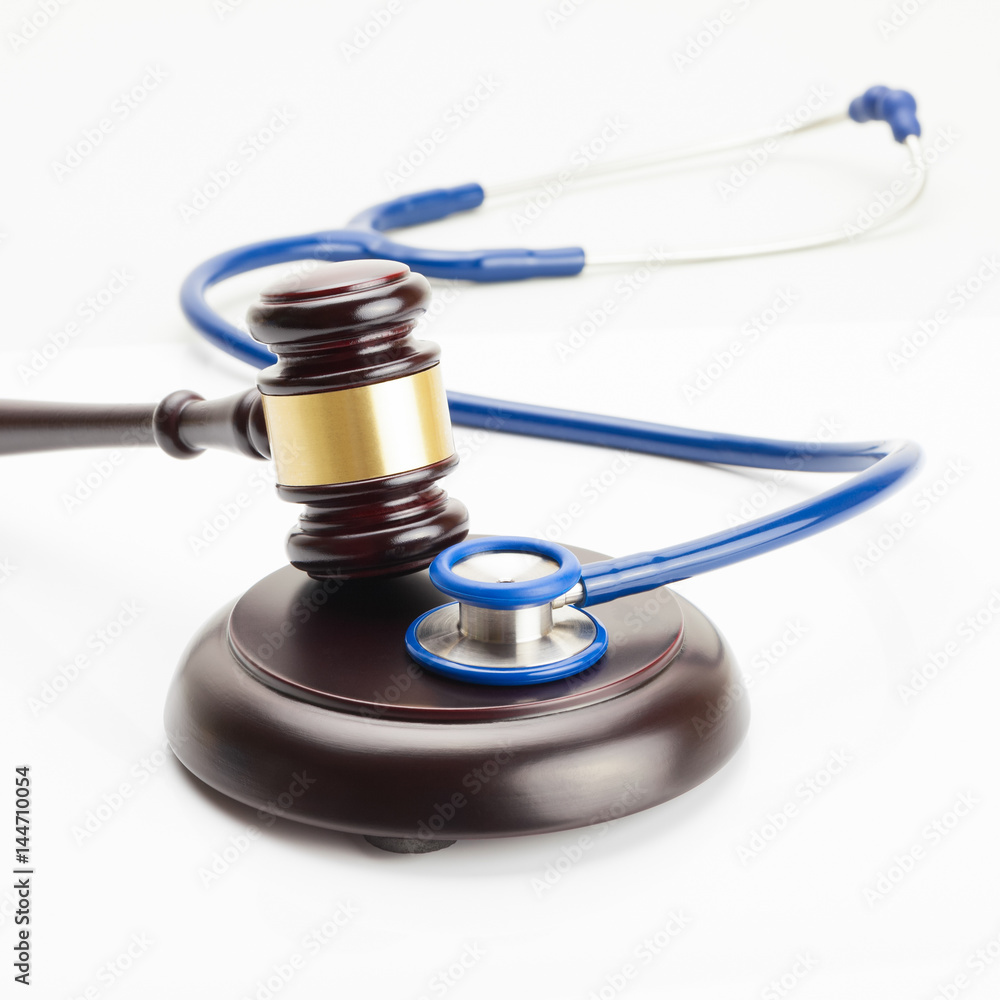 Close up shot of a judge gavel and a stethoscope Close up shot of a judge gavel and a stethoscope
