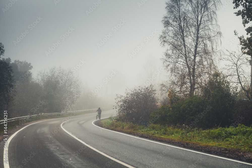 Empty rural road turn in autumn foggy morning Empty rural road turn in autumn foggy morning