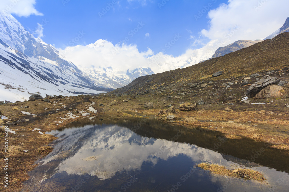 Himalaya Annapurna snow mountain range with reflection on pond, Nepal