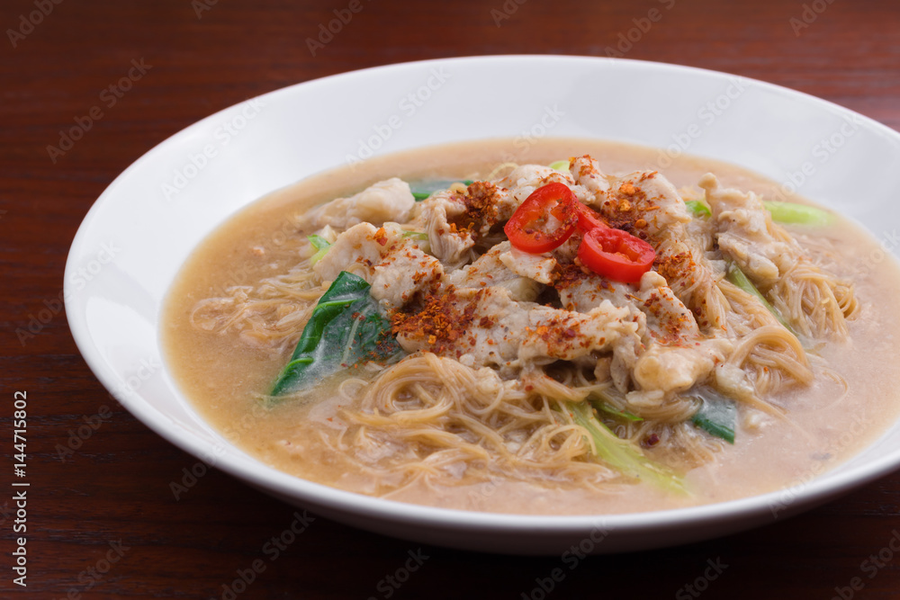 Fried noodle with pork and vegetable. Thai-Chinese noodle dish 
