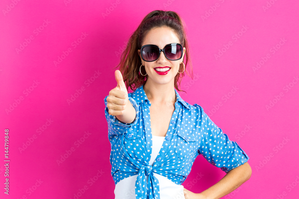 Happy young woman giving a thumbs up Happy young woman giving a thumbs up