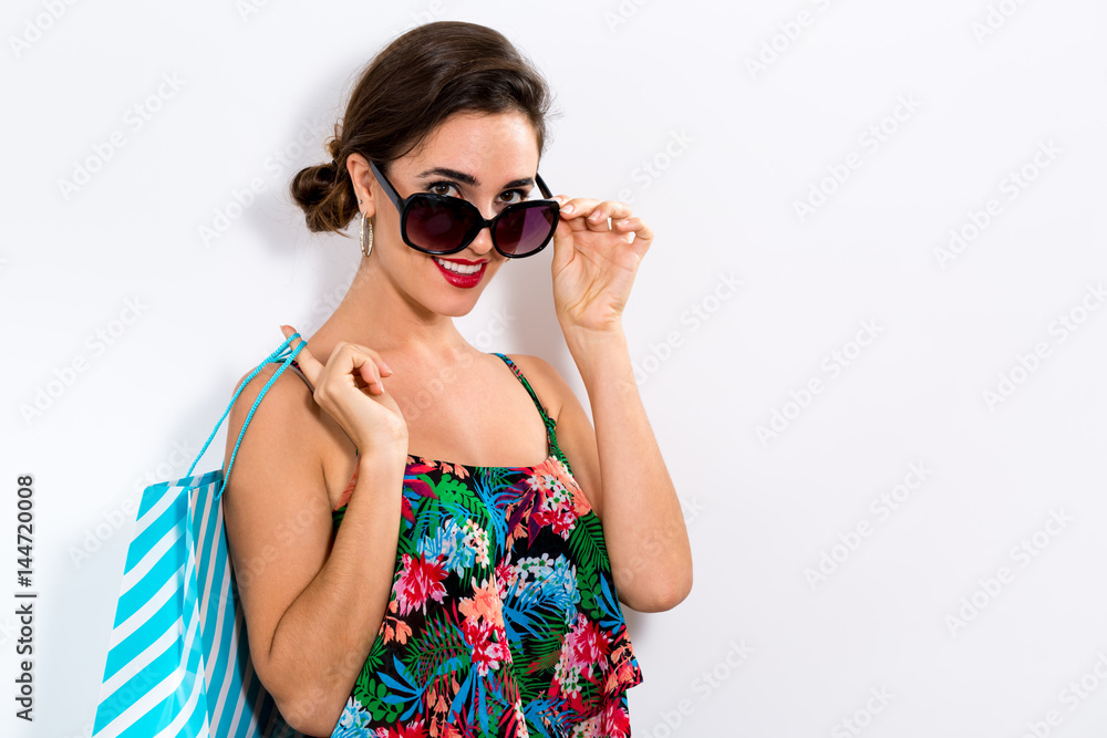 Happy young woman holding a shopping bag Happy young woman holding a shopping bag