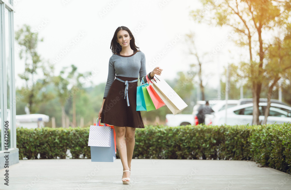 Asia Woman holding many shopping bags in fashion boutique Asia Woman holding many shopping bags in fashion boutique