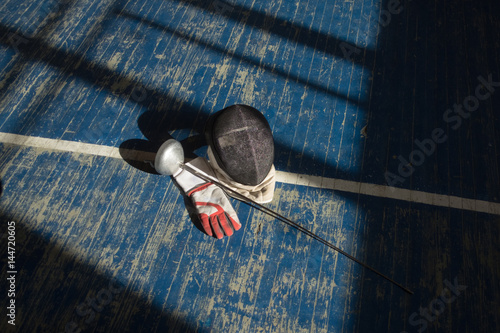 the fencer prepares for competitions. fencing coach. fencing sport motivation. mask and sword