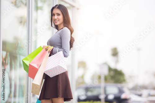 Asia Woman holding many shopping bags in fashion boutique