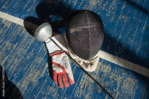 the fencer prepares for competitions. fencing coach. fencing sport motivation. mask and sword
