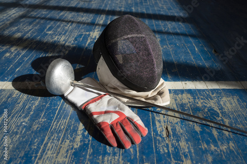 the fencer prepares for competitions. fencing coach. fencing sport motivation. mask and sword