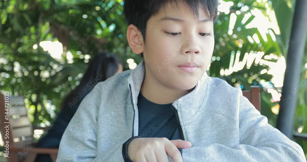 Asian child in student uniform reading and writing to do homework of the school . Asian child in student uniform reading and writing to do homework of the school .
