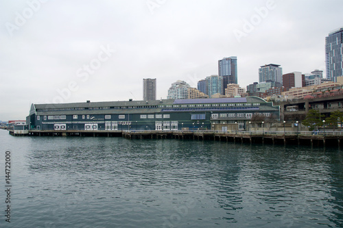 SEATTLE  WASHINGTON  USA - JAN 25th  2017  A view on Seattle downtown from the waters of Puget Sound. Piers  skyscrapers  Seattle Aquarium in the city before sunset