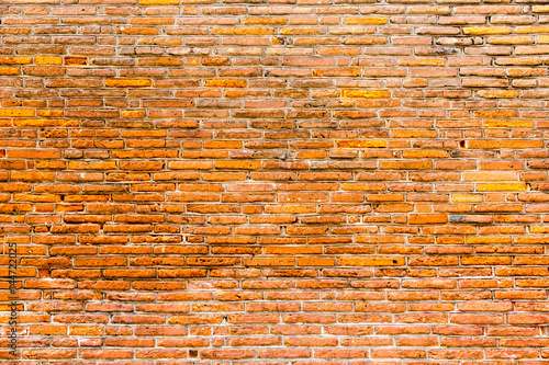 Orange pink old thin bricks work wall. Backgrounds full frame