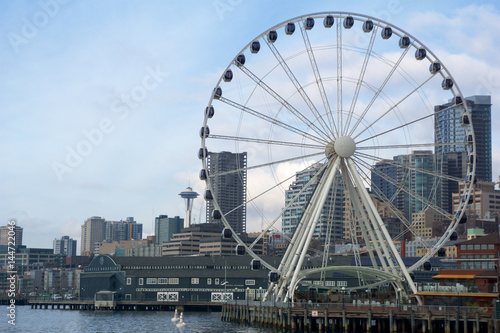 SEATTLE  WASHINGTON  USA - JAN 25th  2017  A view on Seattle downtown from the waters of Puget Sound. Piers  skyscrapers  Space Needle and Ferris wheel in Seattle city before sunset