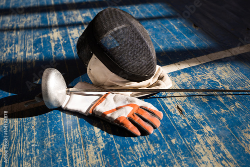 the fencer prepares for competitions. fencing coach. fencing sport motivation. mask and sword