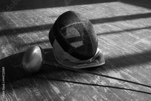 the fencer prepares for competitions. fencing coach. fencing sport motivation. mask and sword