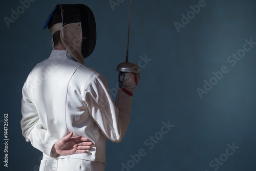 the fencer prepares for competitions. fencing coach. fencing sport motivation. mask and sword