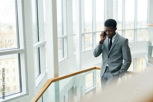 African-american employer consulting someone on the phone
