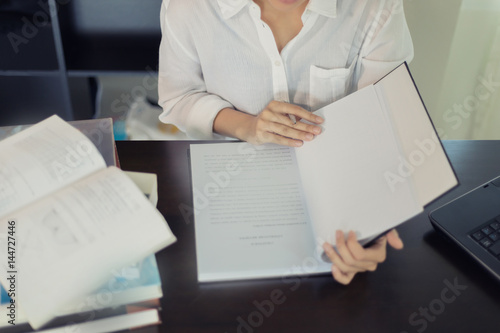 Asian women student reading a book for relaxation and final exam