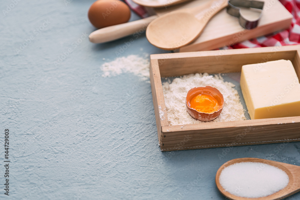 Baking cake in rural kitchen - dough recipe ingredients (eggs, flour, milk, butter, sugar) on white wooden table from above. Baking cake in rural kitchen - dough recipe ingredients (eggs, flour, milk, butter, sugar) on white wooden table from above.