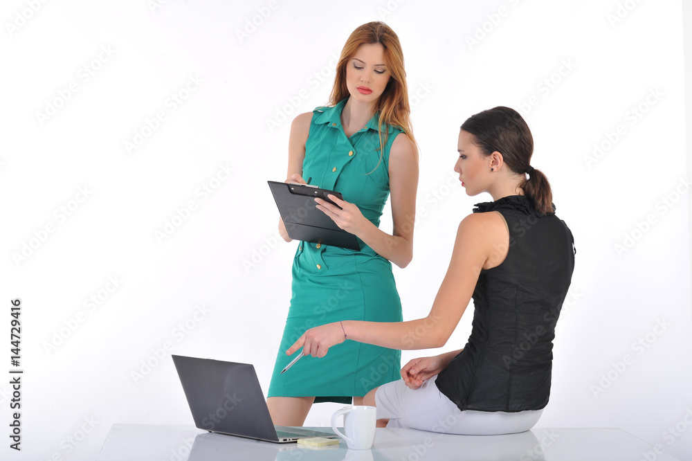 two young woman working together on laptop computer two young woman working together on laptop computer