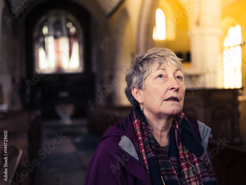 Senior woman exploring church photo