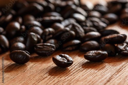 Roasted coffee beans espresso with a wood background