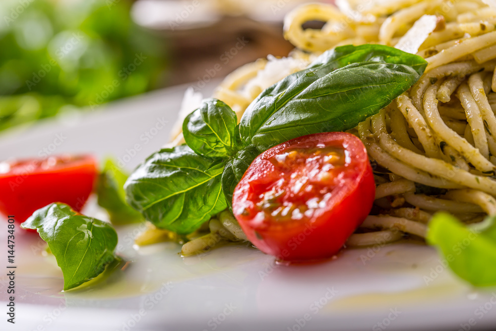 Spaghetti. Italian pasta spaghetti with basil pesto cherry tomatoes and olive oil.