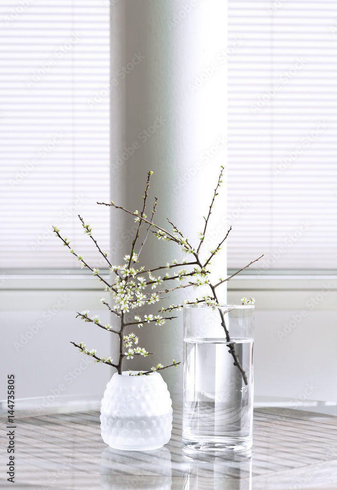 Fototapeta Cherry branches in glass vases.