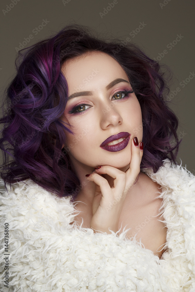 Portrait of young beautiful woman with violet make up and purple hair. Beauty concept. Portrait of young beautiful woman with violet make up and purple hair. Beauty concept.