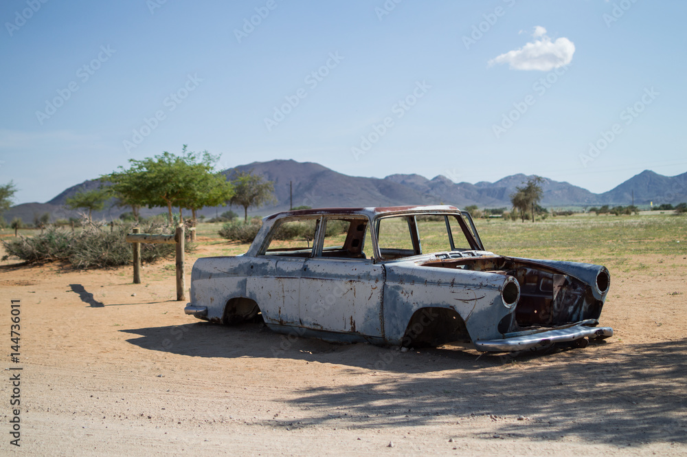Old Timer Car Wreck in Front of a Desert Landscape with Mountains in ...