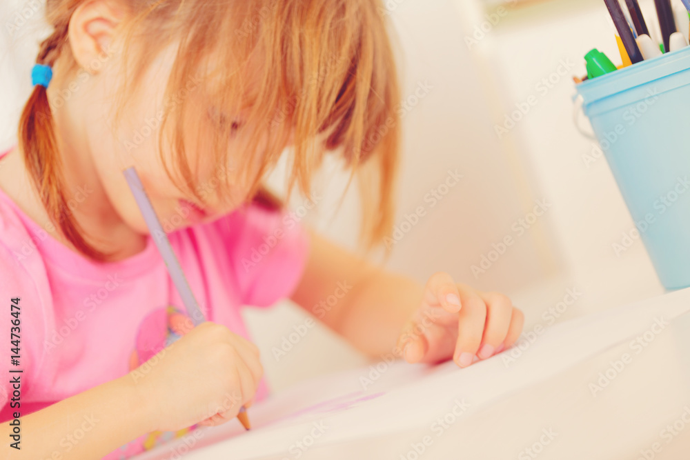 Small girl drawing with colourful pencils Small girl drawing with colourful pencils