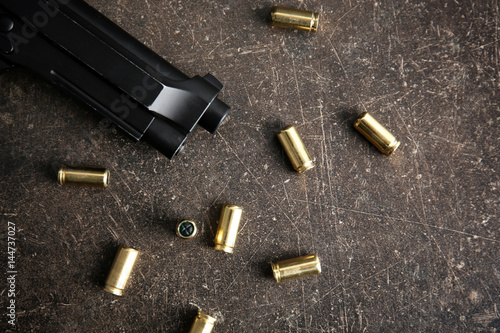 Obraz na plátne Bullets and gun on gray table