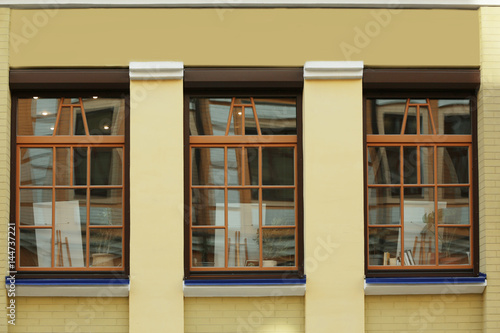 Brown windows with brick wall building background