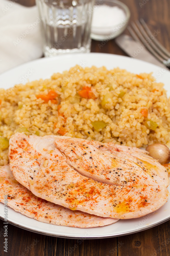 grilled chicken breast with couscous on white dish