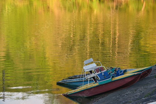 Two old catamarans on the shore of the lake