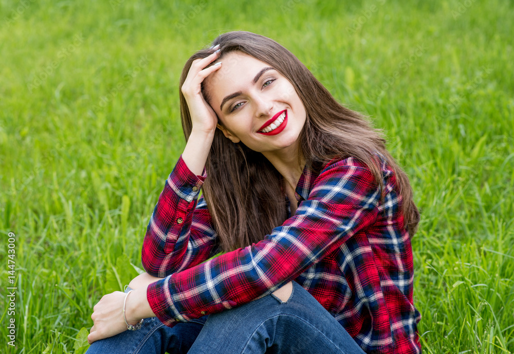 Beautiful Young Woman Outdoors. Enjoy Nature. Healthy Smiling Girl in Green Grass. Beautiful Young Woman Outdoors. Enjoy Nature. Healthy Smiling Girl in Green Grass.