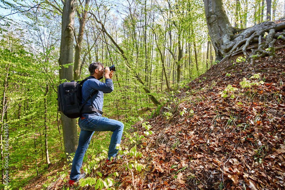 Male tourist with backpack in the forest Male tourist with backpack in the forest