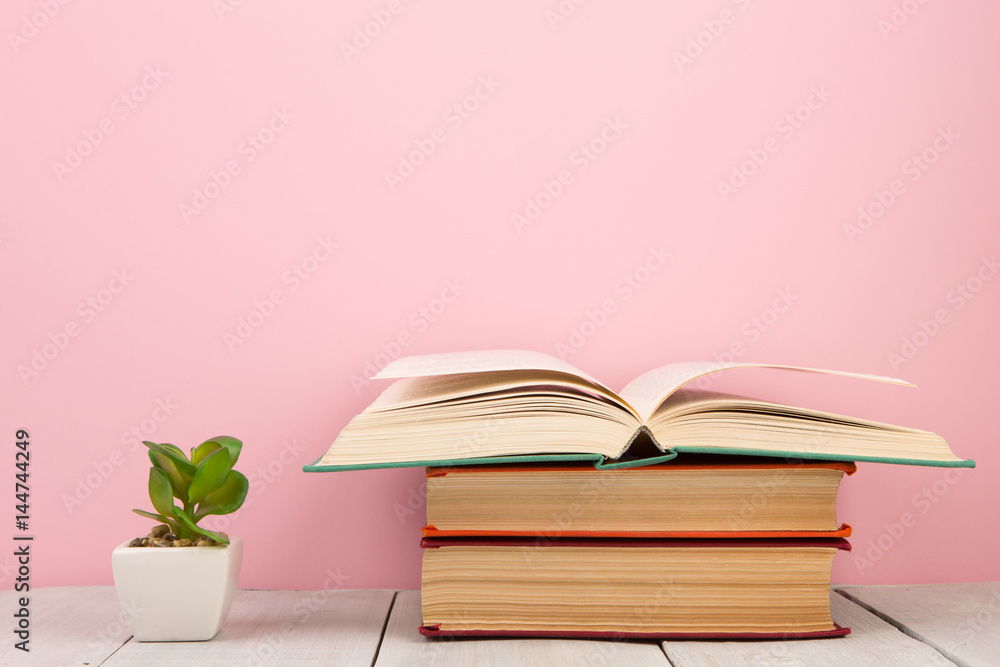 education and wisdom concept - open book on wooden table, color background education and wisdom concept - open book on wooden table, color background