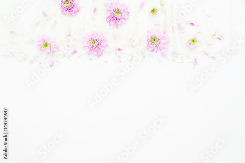 Pink flowers, purple petals on white background. Wedding dress. Flat lay, top view. Feminine  background © artifirsov