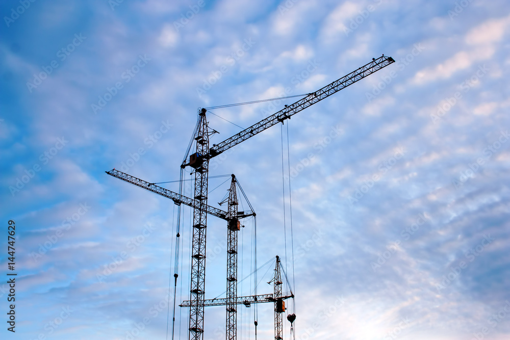 tower cranes at sunset sky background tower cranes at sunset sky background