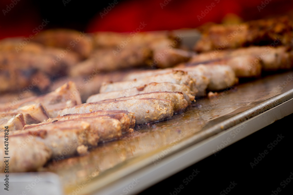 Cooking pork sausages in a street market Cooking pork sausages in a street market