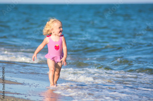 Smiling girl walks by the water