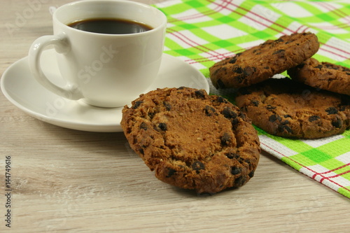 Coffee cup with oatmeal cookie chocolate on wooden background