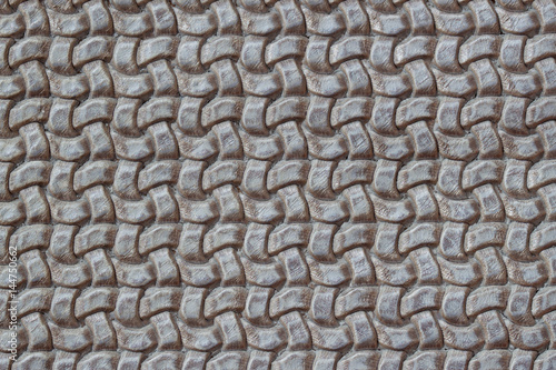 Texture of genuine Braided leather close-up. Fashion trend leather background in grey color, copy space, substrate composition use. Concept of shopping, manufacturing