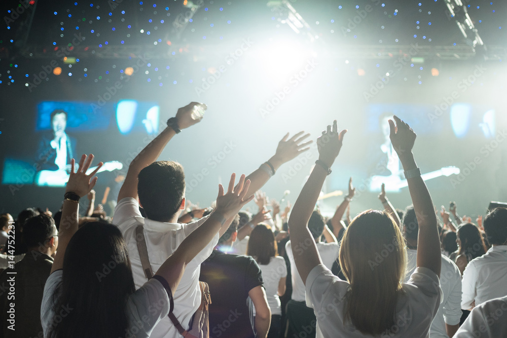 Crowd enjoying concert, large group celebrating new year holiday, party background fun concept