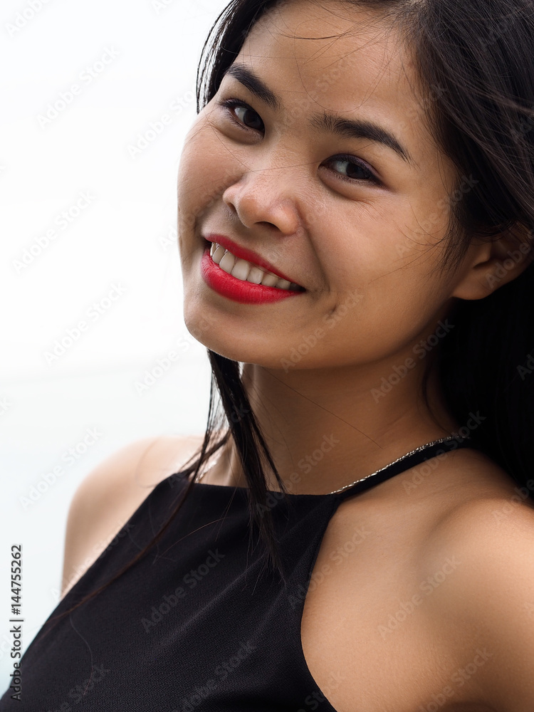Beautiful young brunette vietnam girl wearing black dress Beautiful young brunette vietnam girl wearing black dress