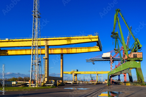 Fotografie Yellow gantry cranes and green crane in the port of Gdansk