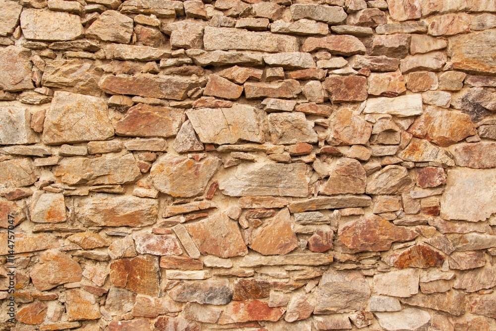 Fototapeta premium Old stone wall. Wall of the castle from the 13th century. Place for your text.