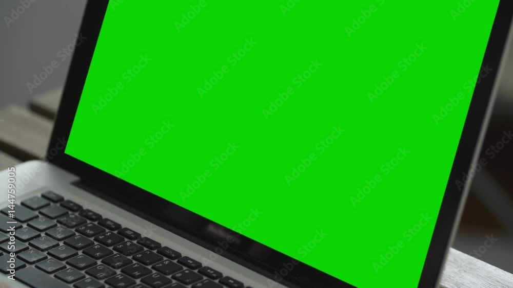 Hand of man working at laptop computer typing on keyboard. Green screen close up Hand of man working at laptop computer typing on keyboard. Green screen close up