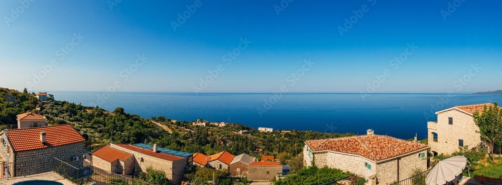 The sea view from the window. Montenegro Coast. The roofs of the villas by the sea