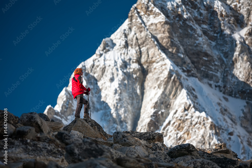 Trekker approaching PumoRi mountain in Khumbu valley on a way to Everest Base camp